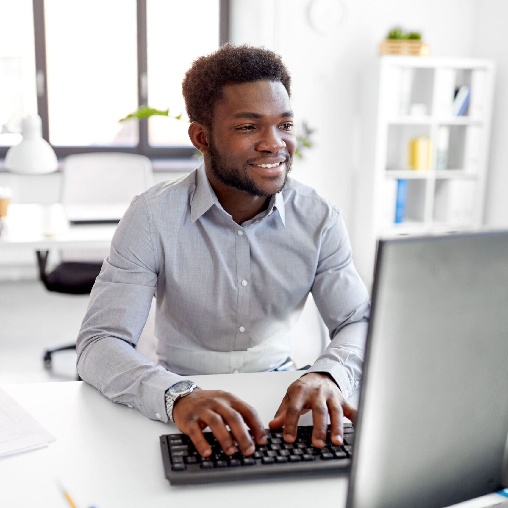 content-management-guy-at-desktop-computer-smiling