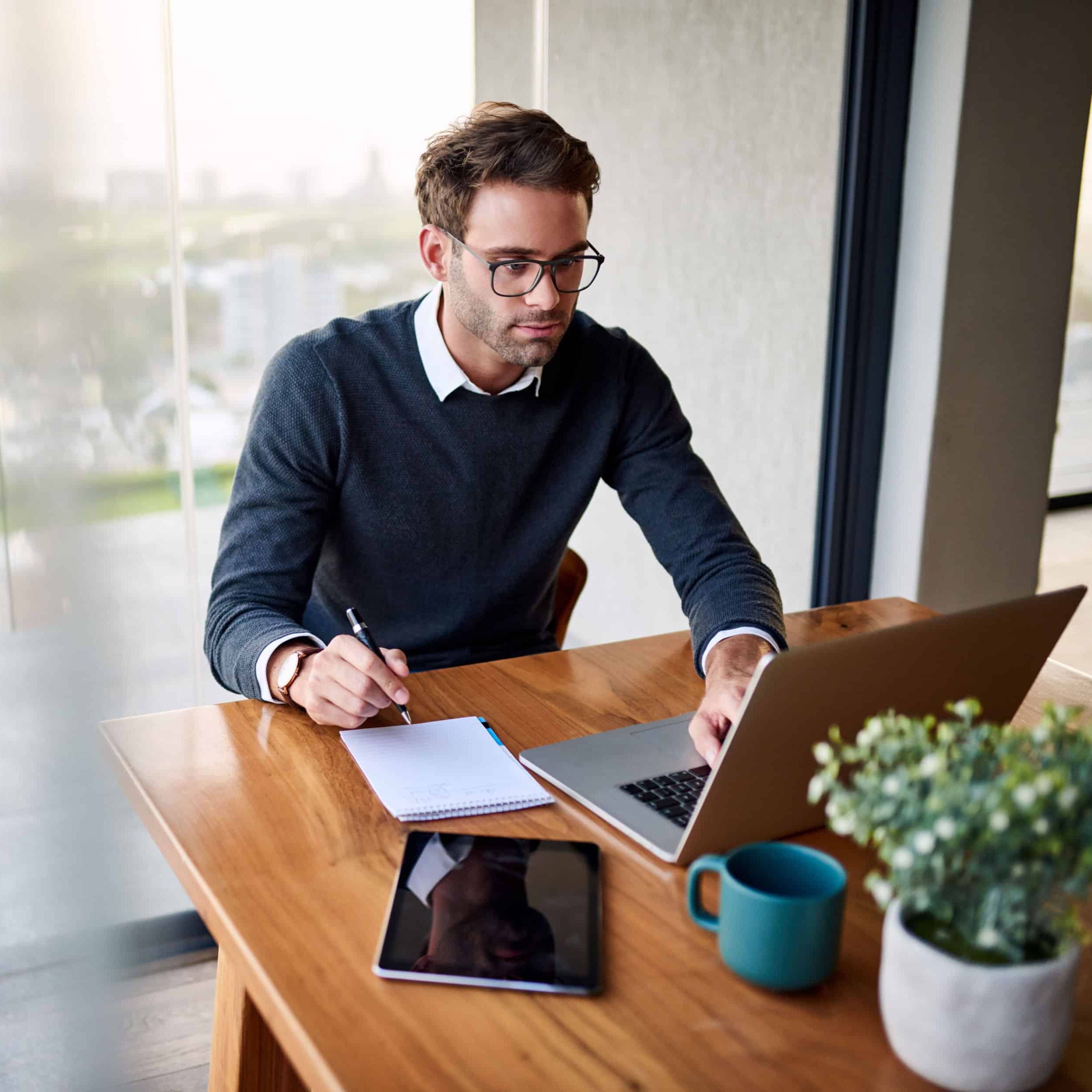 young man working on a laptop remotely for accounts payable automation gets work to your remote team